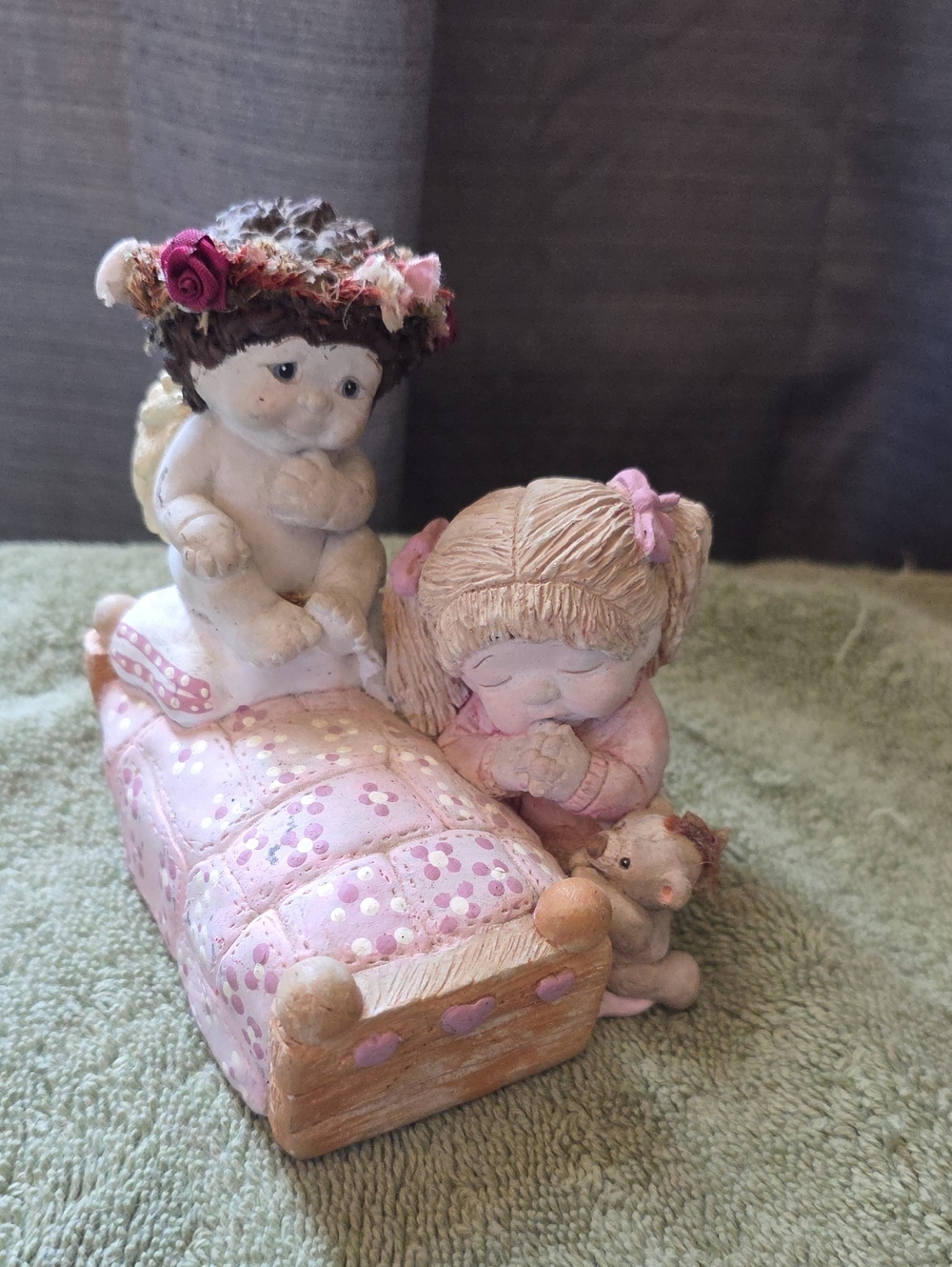 Pink Ceramic Girl and Cherub Figurine on Bed